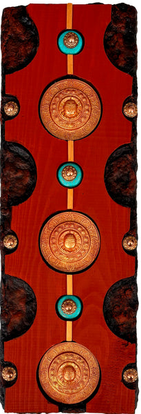 Decorative panel with circular designs and gold accents on a wooden background