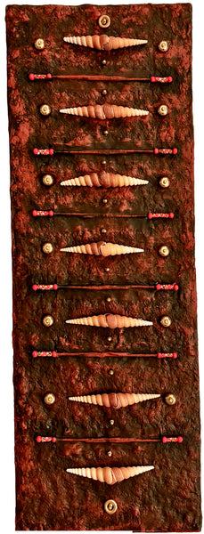 Decorative wall art with shell-like objects on a textured surface