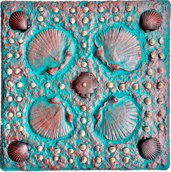 Decorative sculpture with shell patterns on a textured surface