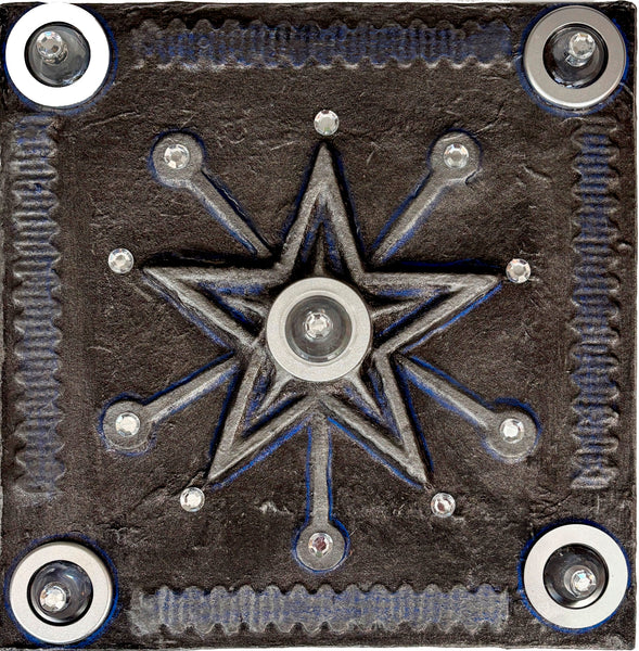 Decorative metal plate with star design and screws on a black background