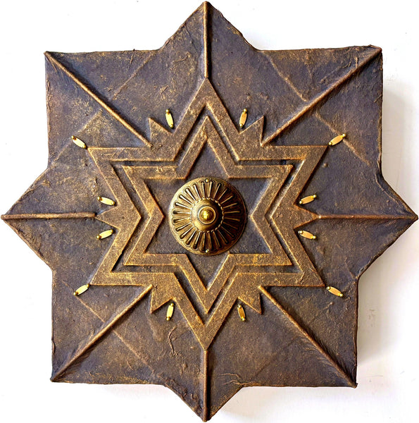Decorative wall art with star design and central emblem 