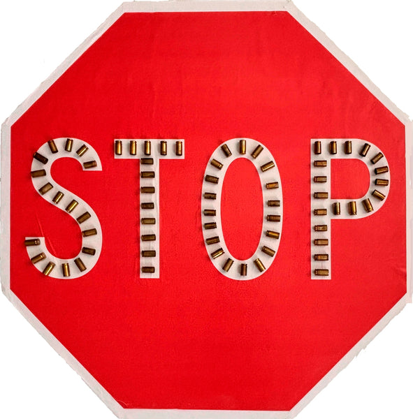 Red stop sign with bullet casings instead of letters 