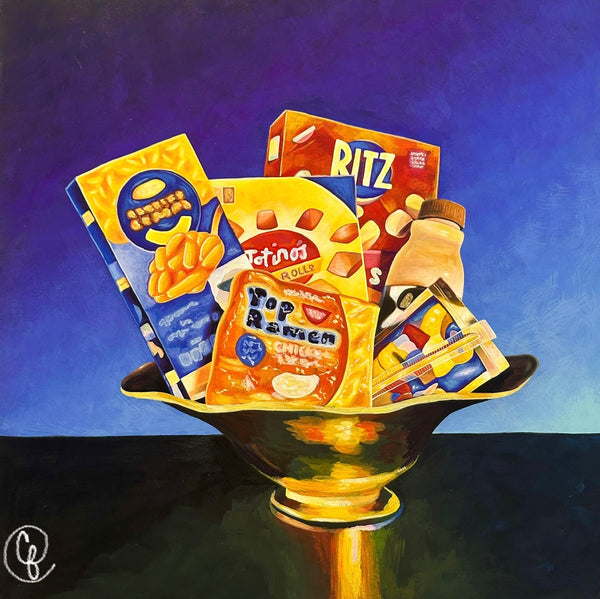 Festive arrangement of snack packages in a decorative bowl against a blue background