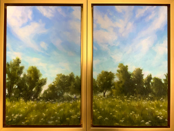 Framed artwork of a landscape with trees and sky.