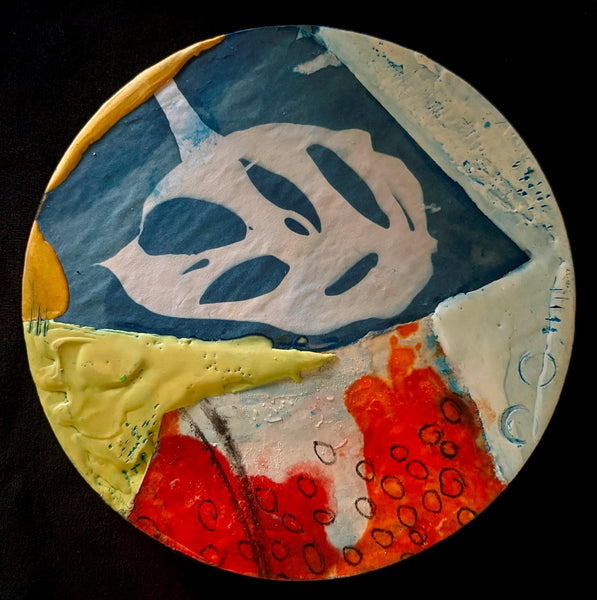 Circular mixed media collage with a leaf shape and blocks of bright color and texture