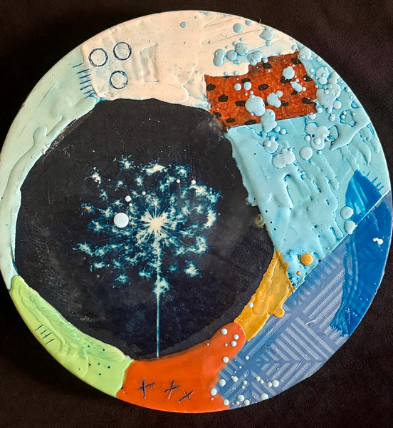 Circular abstract collage with the imprint of a flower and patches of bright colors