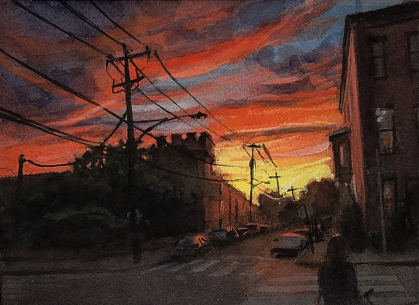 Street scene with telephone poles and wires during a dramatic sunset.