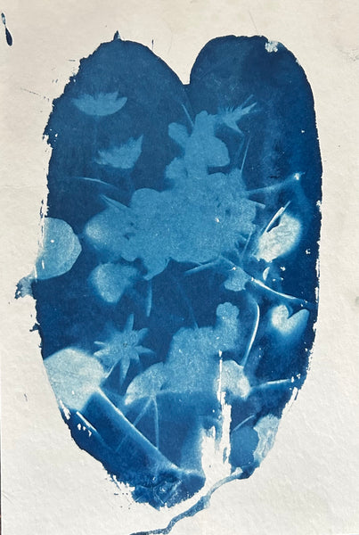 Blue cyanotype print with floral design inside a heart shape