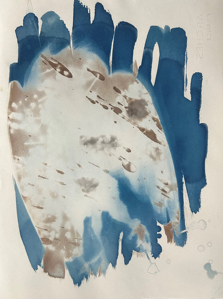 Abstract cyanotype art piece with blue and brown brush strokes on a light background