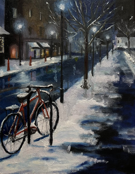 Bicycle leaning against a snow-covered wall on a winter night street scene.