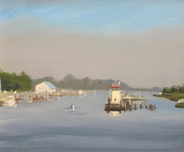 Lighthouse on a dock with a calm body of water and trees in the background