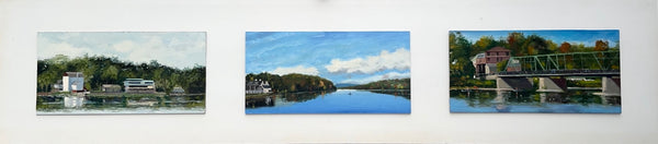 Three paintings of landscapes with rivers and bridges on a white wall.