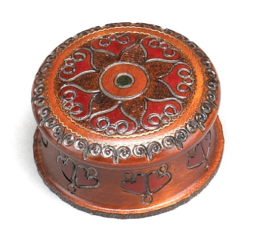 A round carved wooden box with a sunburst design and a central floral motif, finished in a brown stain.