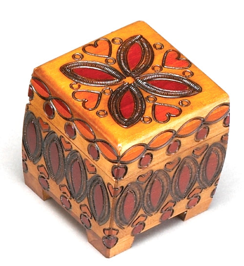 A small, handcrafted wooden box with a floral and heart pattern in red, orange, and yellow colors on the lid.