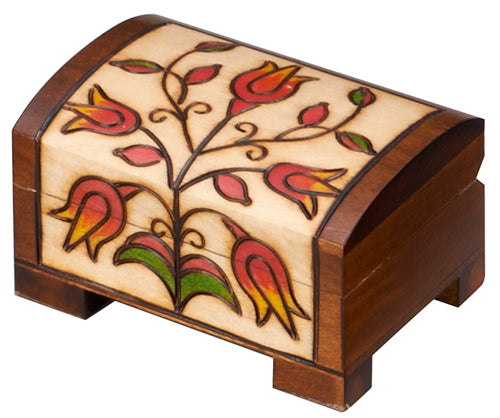 Carved wood chest with floral design.