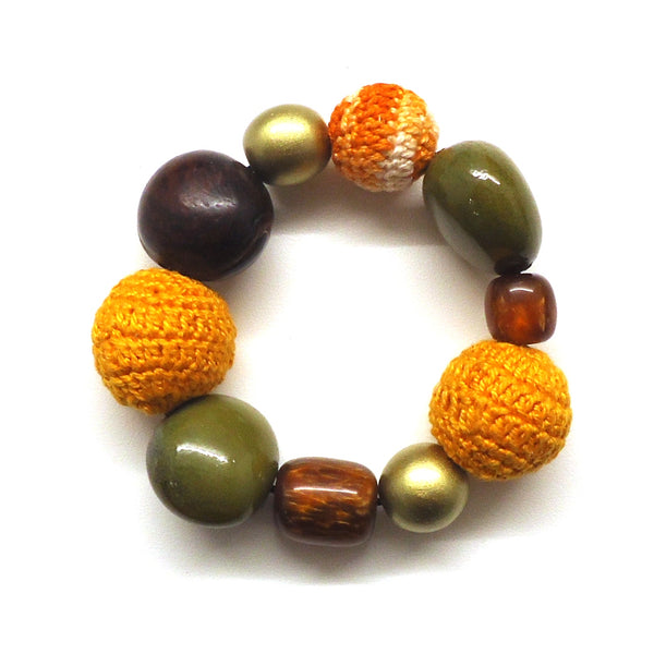 Multi bead bracelet in shades of orange and brown with gold accents available at Cerulean Arts.