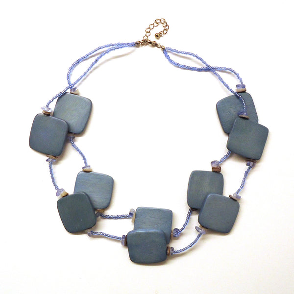 Pale blue double strand necklace with glass seed beads and large square wood beads, available at Cerulean Arts.&nbsp;