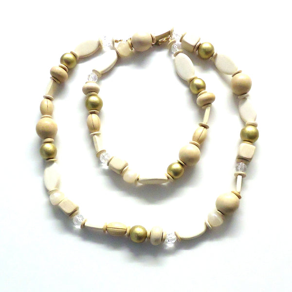 Multi bead necklace in light natural wood tones with metallic gold accents available at Cerulean Arts.