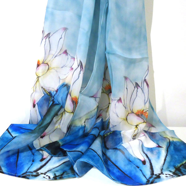 Cupro scarf in shades of blue with orchid design on ends.