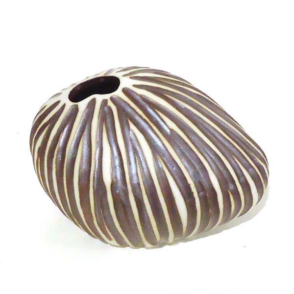 Pebble shaped porcelain bud vase with ribbed design in pewter brown and white available at Cerulean Arts. 