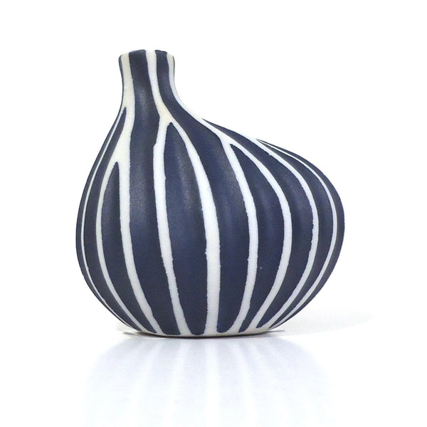 Asymmetrical porcelain bud vase in deep blue with white stripes available at Cerulean Arts.&nbsp;