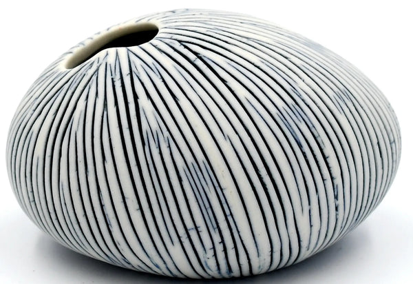 Pebble-shaped porcelain&nbsp;bud&nbsp;vase with fine black stripes available at Cerulean Arts.