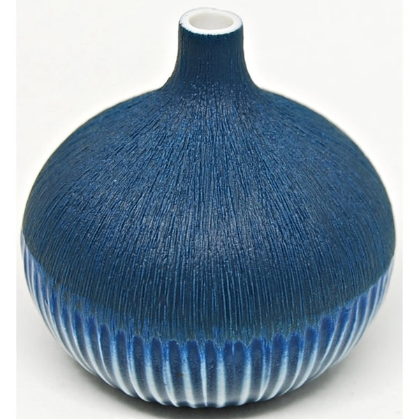 Gourd shaped porcelain bud vase in deep blue with matte textured upper half and glossy striped lower half, available at Cerulean Arts. 
