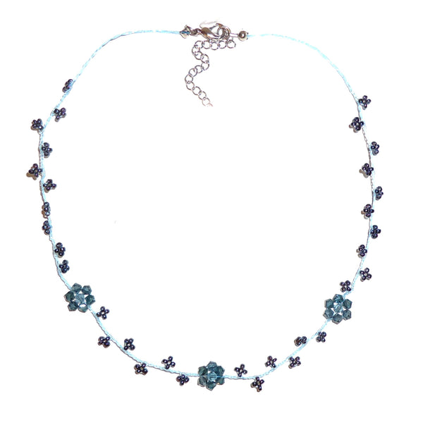 Necklace with denim blue seed beads delicately strung in flower shapes on nylon cording available at Cerulean Arts.