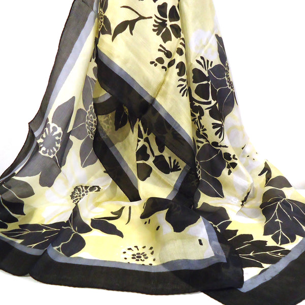 Silk scarf with bold floral pattern in black and yellow available at Cerulean Arts.