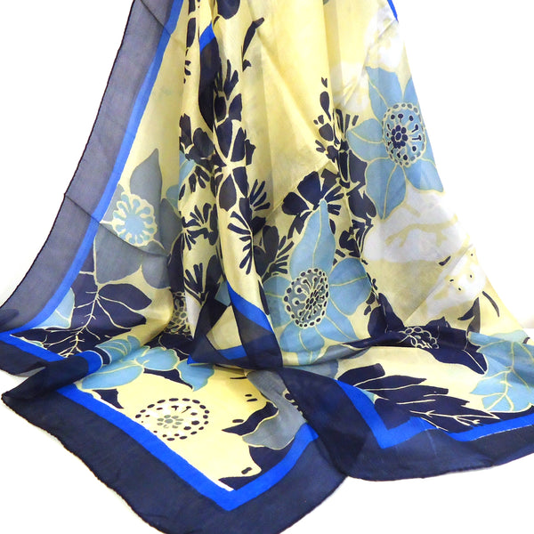 Silk scarf with bold floral pattern in blue and yellow available at Cerulean Arts. 