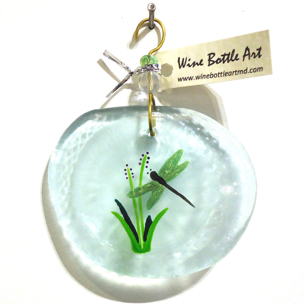 Pale blue glass suncatcher with green dragonfly made from a recycled wine bottle available at Cerulean Arts. 