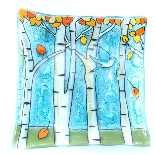 Fused glass small plate featuring fall aspen trees with flying blue bird available at Cerulean Arts. 