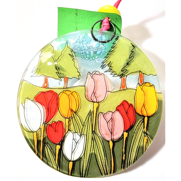 Fused glass suncatcher featuring a patch of blooming tulips available at Cerulean Arts. 