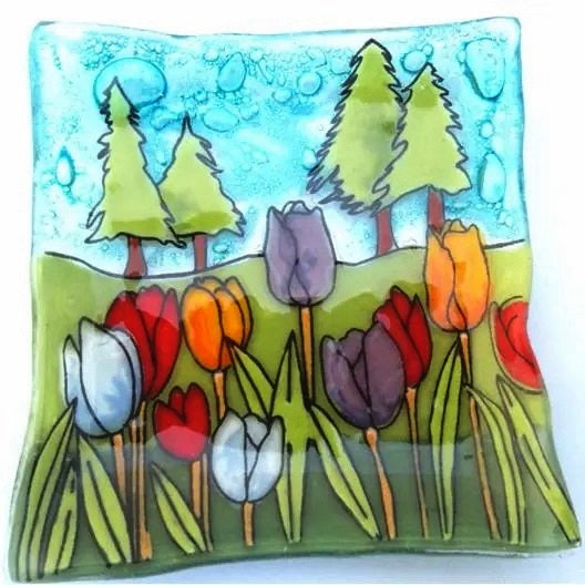 Fused glass small plate featuring a field of tulips available at Cerulean Arts. 