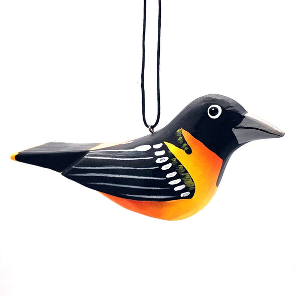 Balsa wood oriole ornament hand-carved and painted with non-toxic acrylic paints by a cooperative of artisans on Isla Solentiname, Nicaragua, available at Cerulean Arts. 