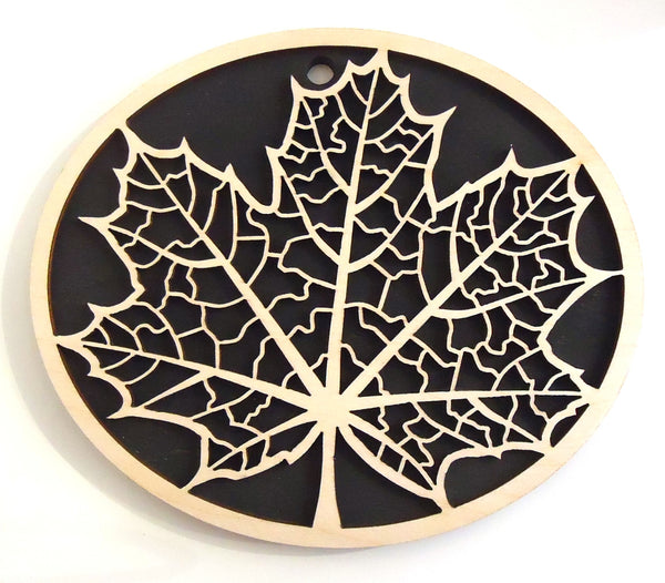 Laser-cut maple leaf wood trivet by veteran Robert E. Jones of Baltic by Design, available at Cerulean Arts. 